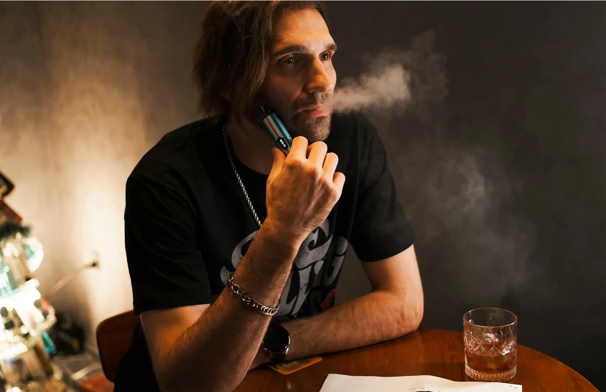 A man exhaling vapor from a VAPORESSO VIBE device, highlighting the "DUAL MESH" technology for enhanced flavor and vapor production.
